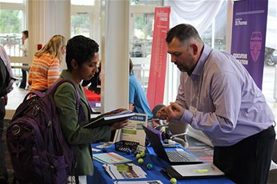Resource exhibitor speaking with guest at an MCN conference