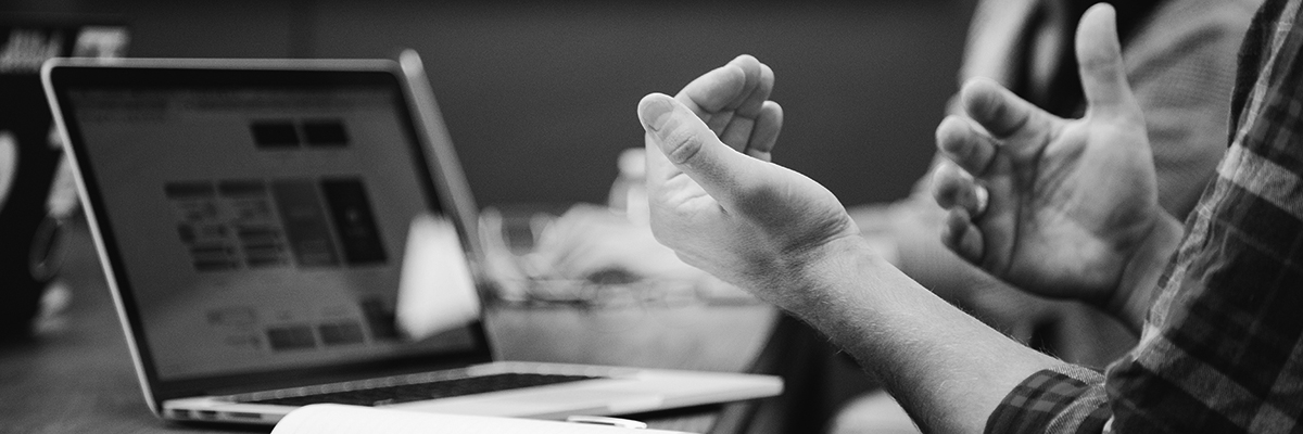 Individual having a discussion in front of a laptop