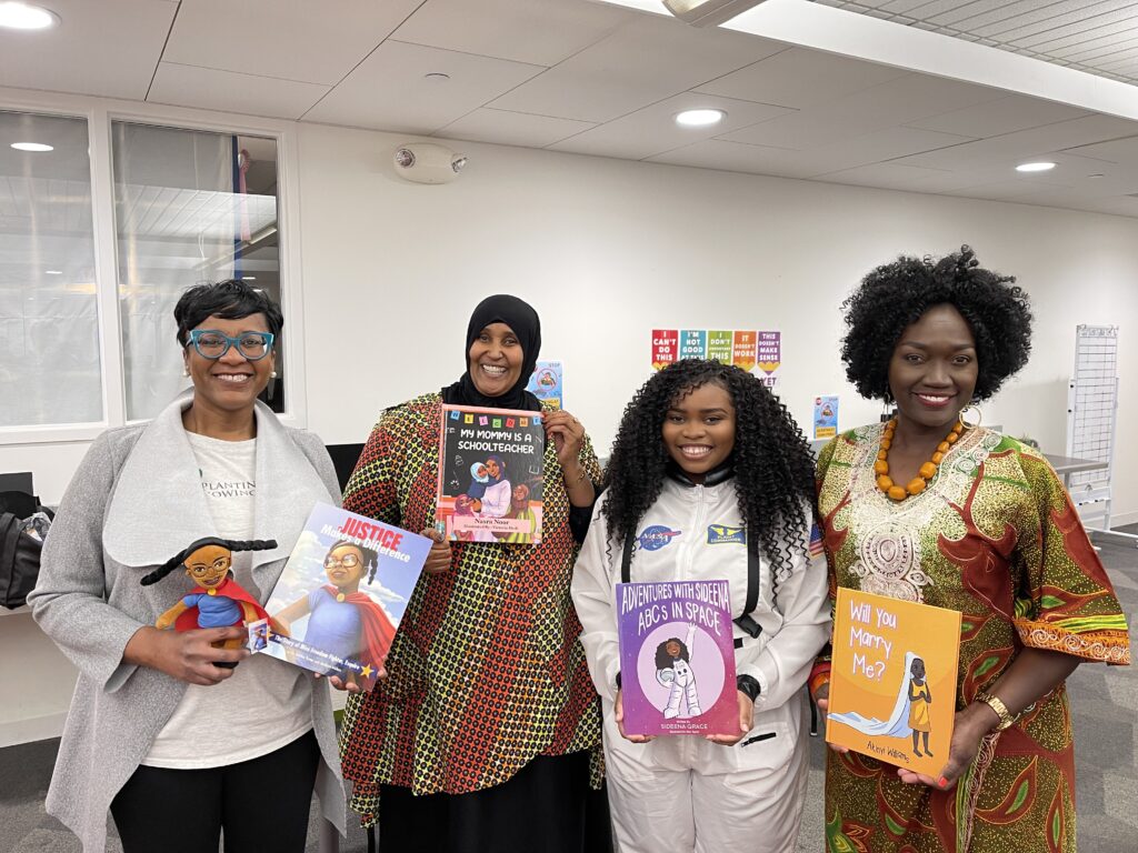 Participants of Planting People Growing Justice Leadership Institute's "Leaders are Readers" program hold books